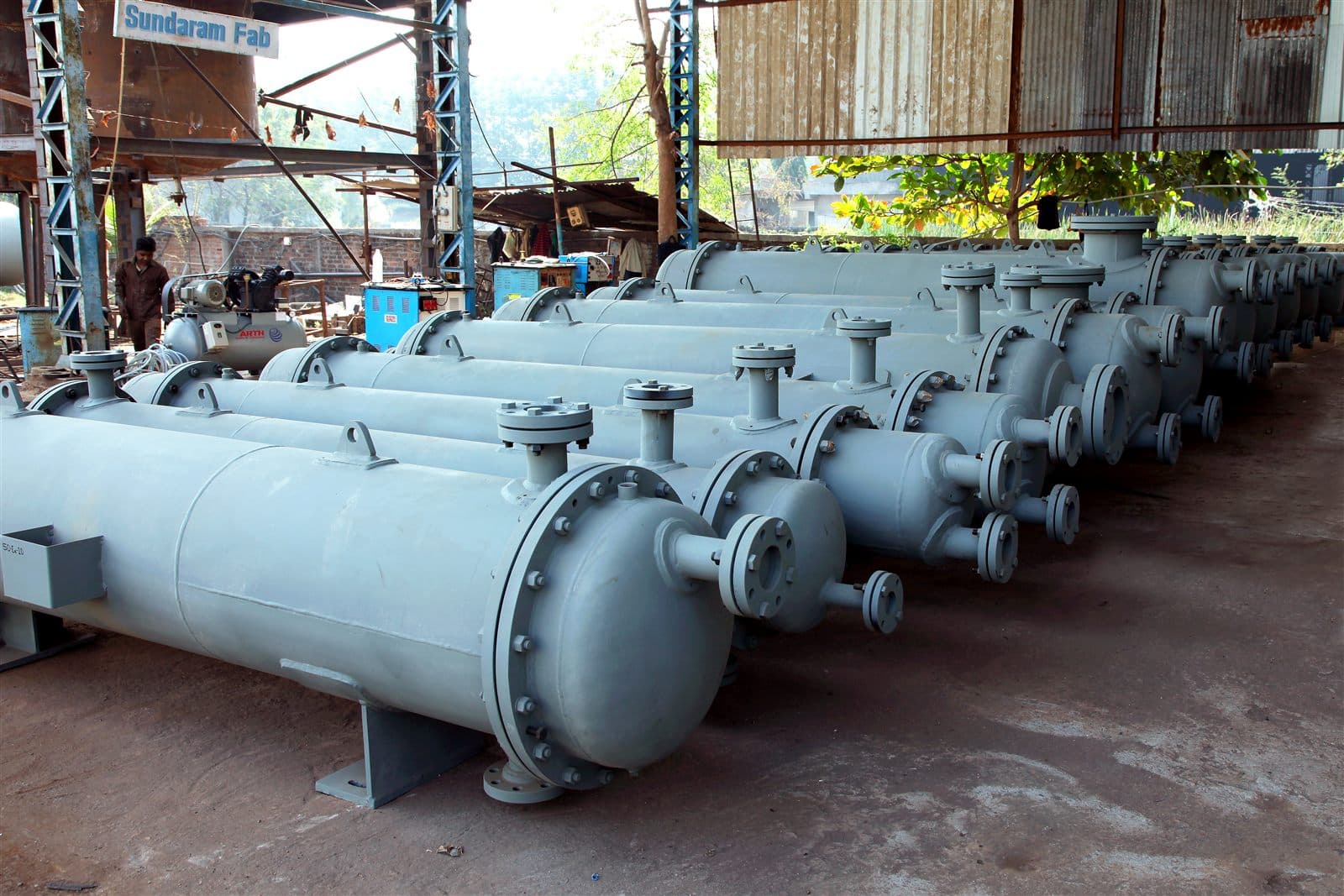 Shell and tube heat exchangers lined up in manufacturing bay ready for dispatch